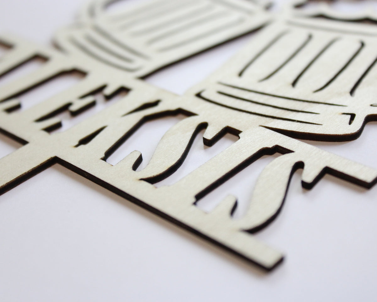 Wooden cutout shapes of a beer mug white background