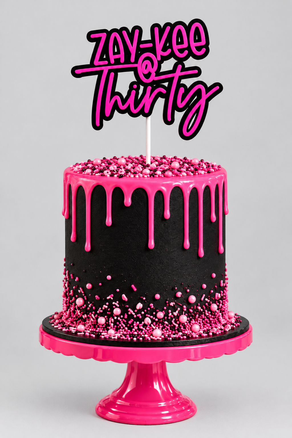 A pink and black birthday cake with rose decorations and a custom topper '@ Thirty', displayed on a pink stand against a festive black and pink party backdrop.